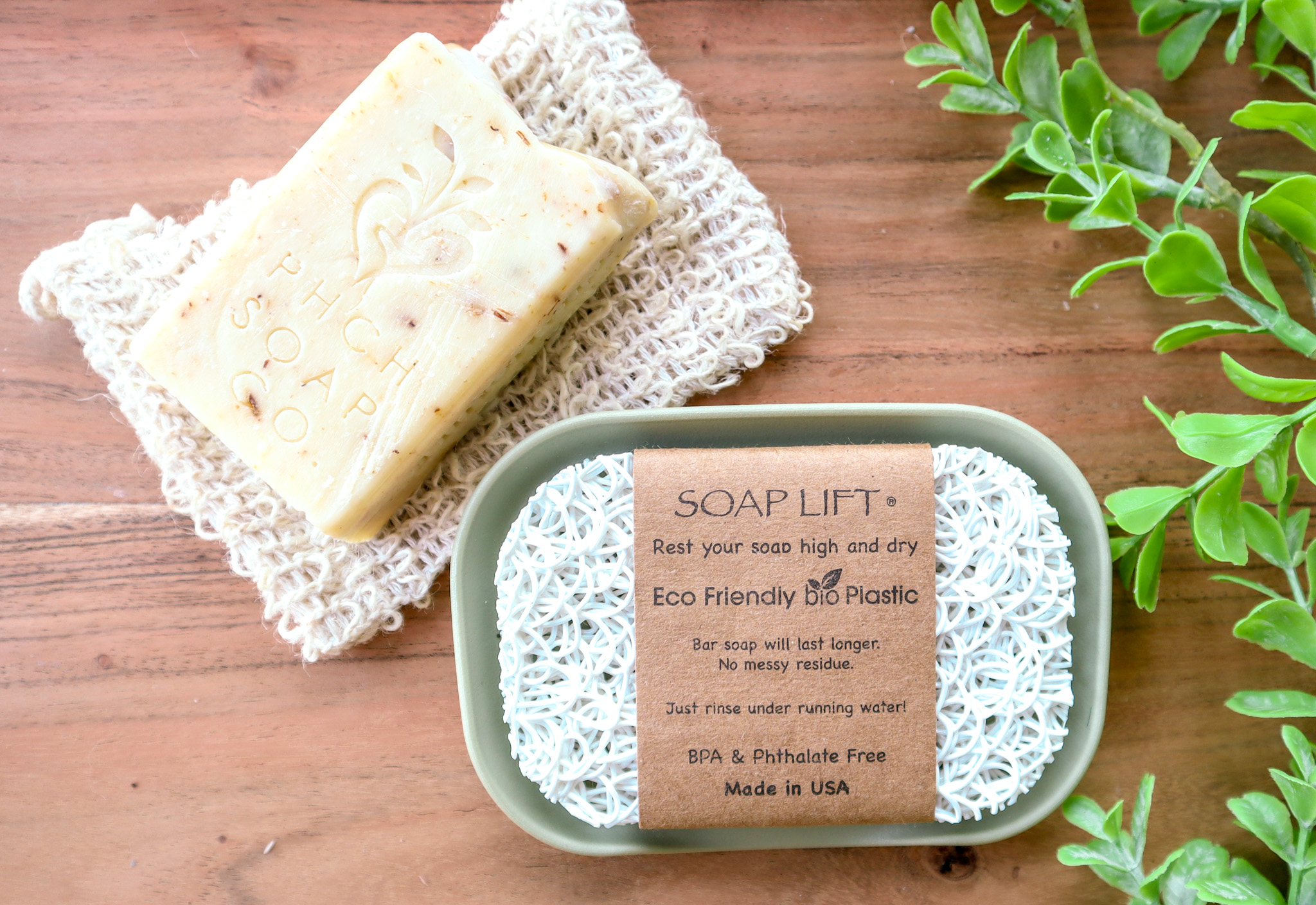 White soap lift on green dish sitting on wood background