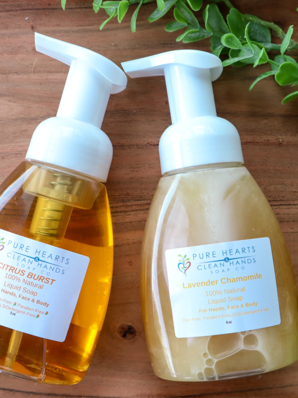 two liquid soap bottles on wood background